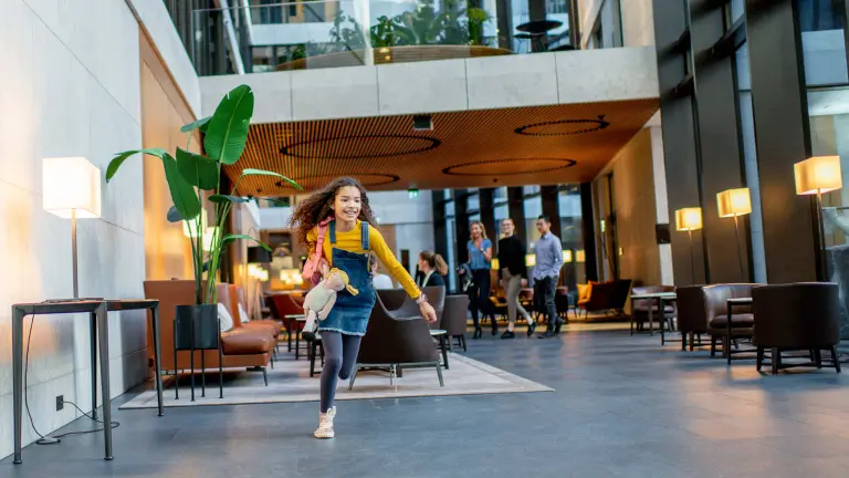 Girls runs through lobby of office building equipped by Bosch
