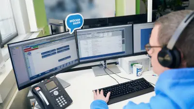 Matthias Hildebrandt, Shift Manager at Bosch emergency call and service control center Magdeburg, Germany, at his working station with headseat and three screens