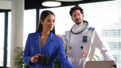 A customer is looking at her laptop. The datanaut has their hand on her shoulder, symbolizing the support through the digital services. 