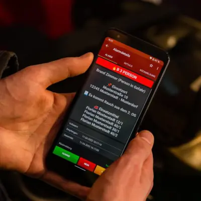 Feuerwehrmann erhält mobile Alarmierung zu einem Brand