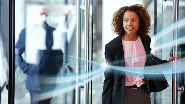 Woman enters networked building - planning, optimization and operation with cloud solutions and digital twins