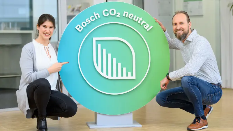 Lisa Reehten and Philipp Günther next to Bosch CO<sub>2</sub>-neutral logo