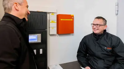 Bosch associates Roland Simion (left) and Michel Huger at work in the fire alarm control center.