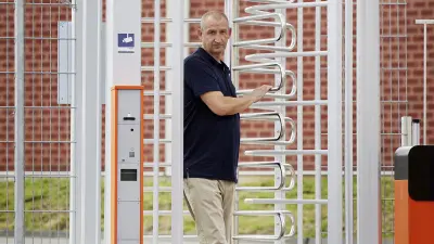Truck driver entering security gate at Autohof Frechen.