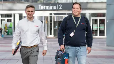 Florian Halsner and Alexander Schäffl from Bosch walk through the passage near terminal two