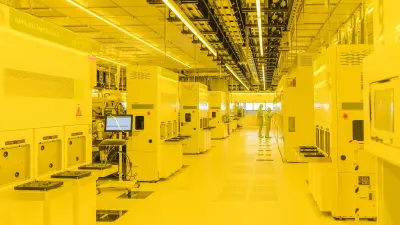 Yellow illuminated cleanroom with two employees