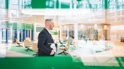 Marius Kaiser walks through the lobby of the Service & Supply Chain Campus in Stuttgart-Feuerbach