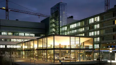 Night shot of the Robert Bosch Hospital with construction cranes in the background