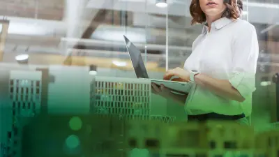 Woman with notebook, in foreground building model
