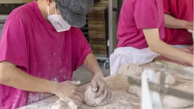 Employees in the bakery of the Sozialwerk Am Bruckwald at work in the bakehouse