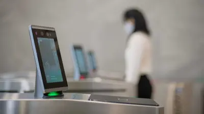 Employee stands at the access control in the entrance area