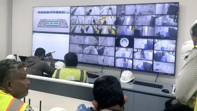 people in room in front of screens