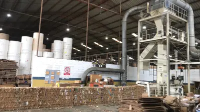 Paper factory hall with cardboard lying on the floor