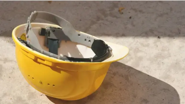 zoomed in image of a yellow helmet that lies on the floor