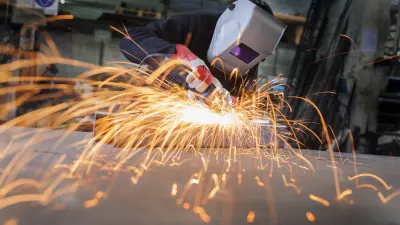 Man welding in industrial factory