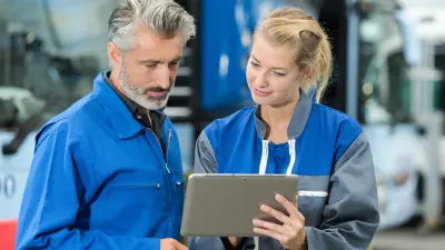 Two maintenance employees with a tablet