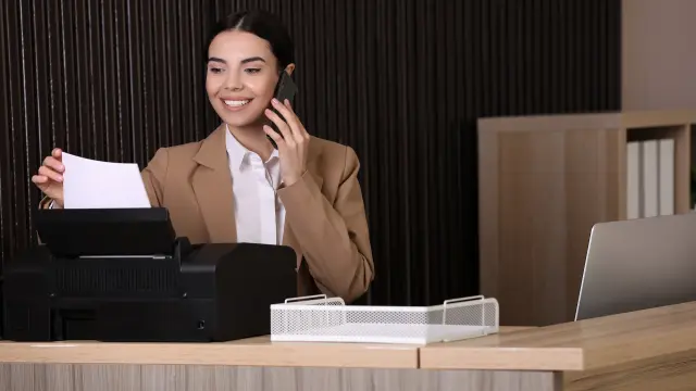 Hotel reception, employee on the phone