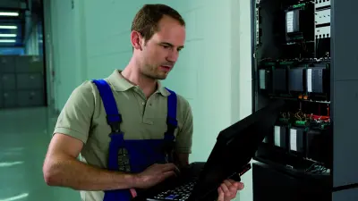 Man sitting and looking at a notebook
