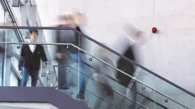 Fire brigade with red engine extinguishing a fire