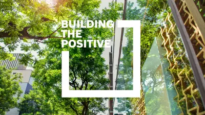 Buildings in a city surrounded by green trees, with sustainable wooden and glass architecture